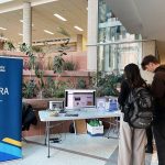 Students standing in front of a computer watching the new aurora video