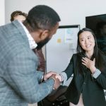 a lady and man shaking hands