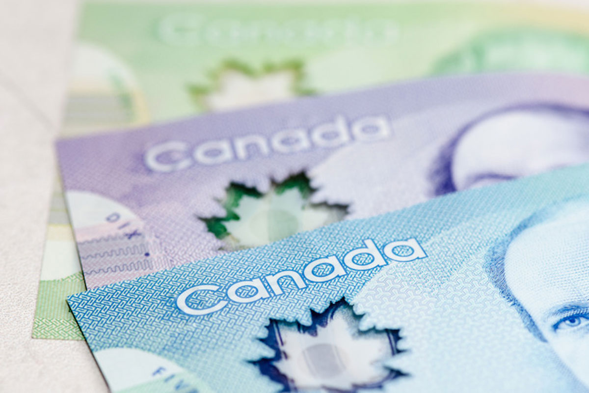A close up of Canadian 5, 10 and 20 dollar bills.