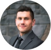 Headshot of a smiling law student in grey suit, shirt and black tie. Reece Cymbalisty 2L